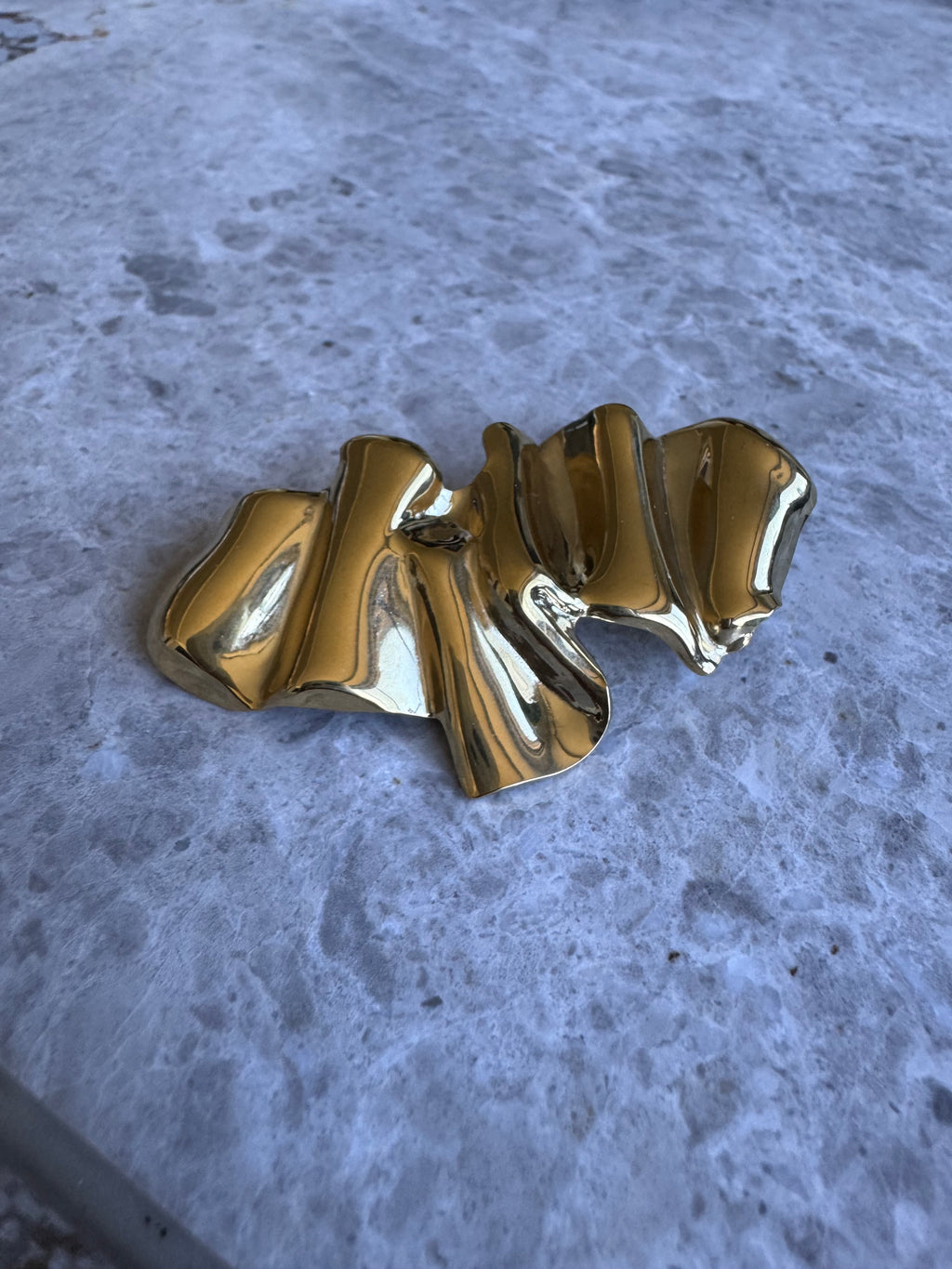 Golden abstract brooch